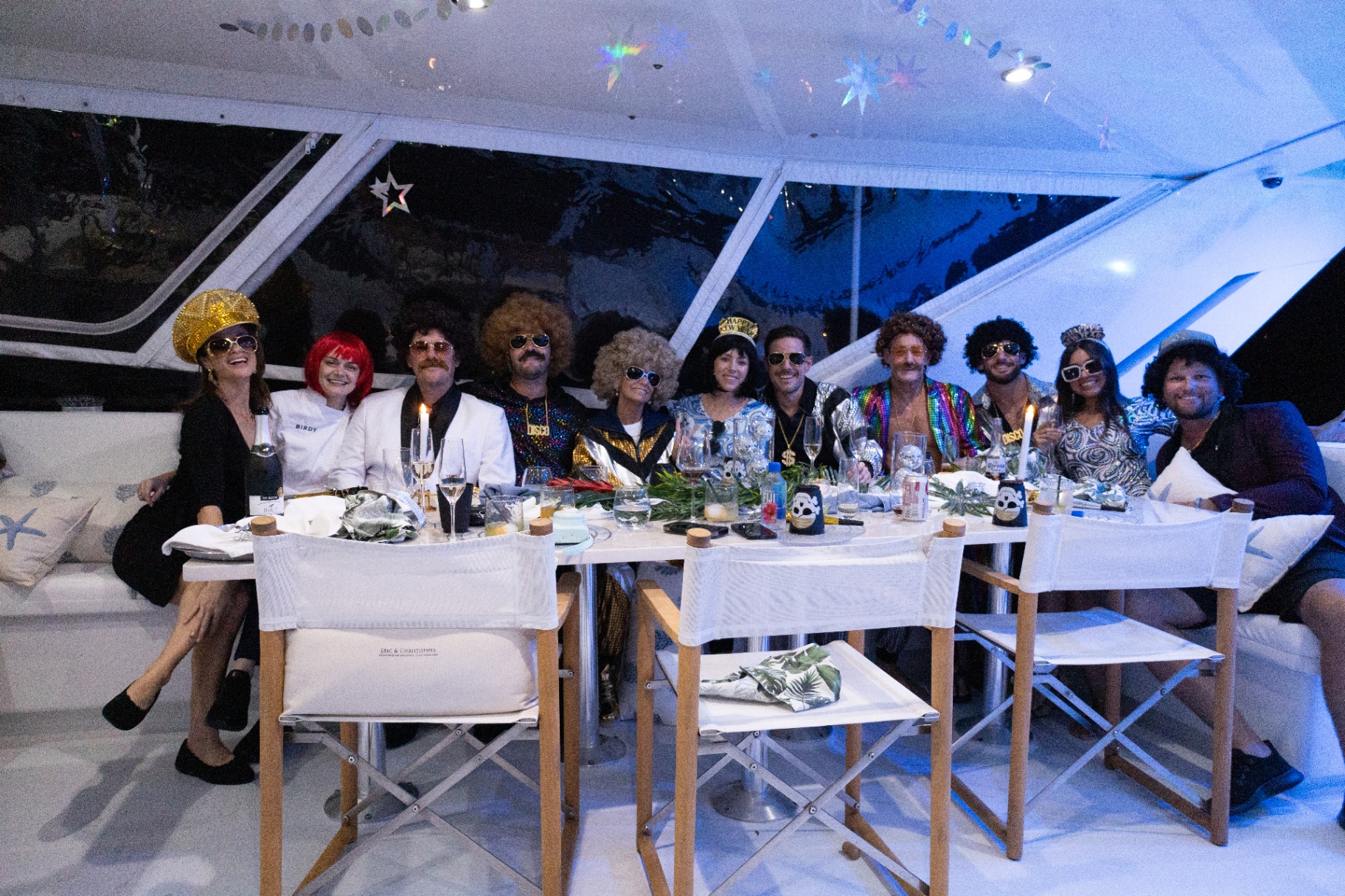 Guests in costume for a disco-themed dinner aboard Birdy