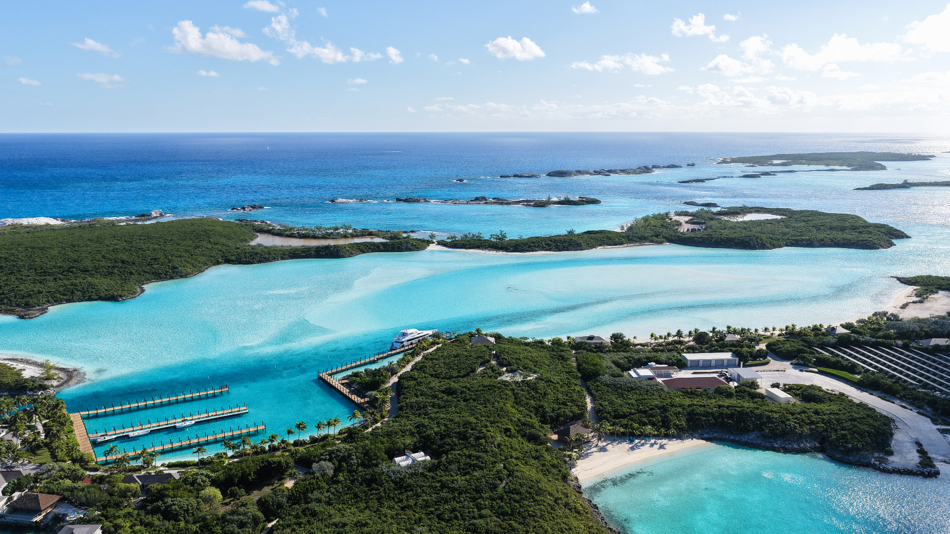 Aerial view of a turquoise cove and marina in the Exumas