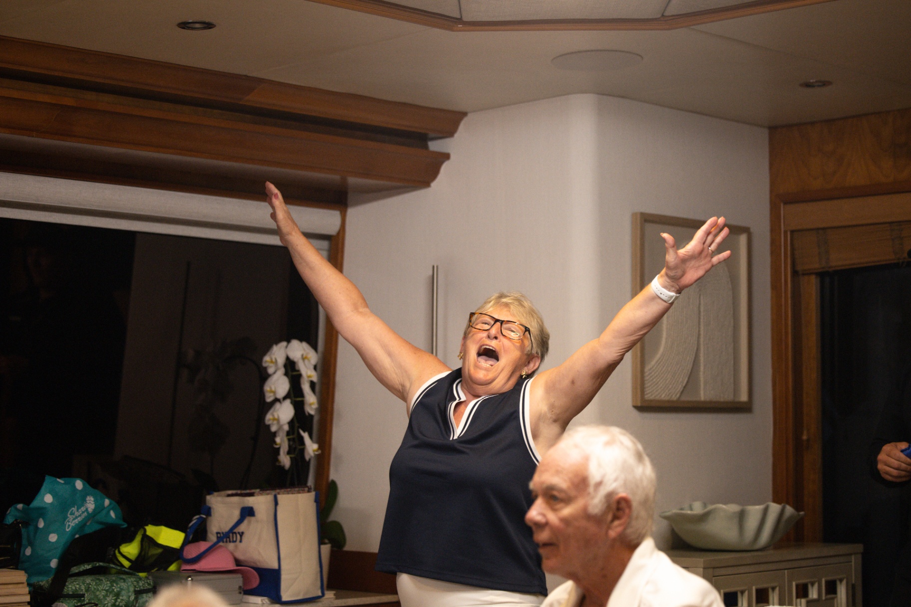 Guest cheering with arms raised inside the salon